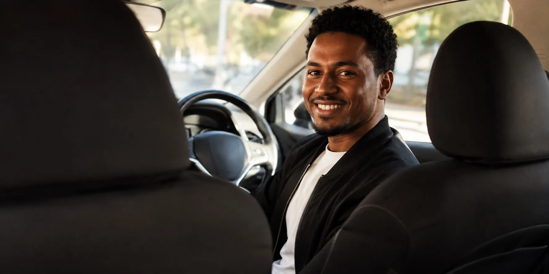 Smiling Yango by Mereq driver behind the wheel in Addis Ababa